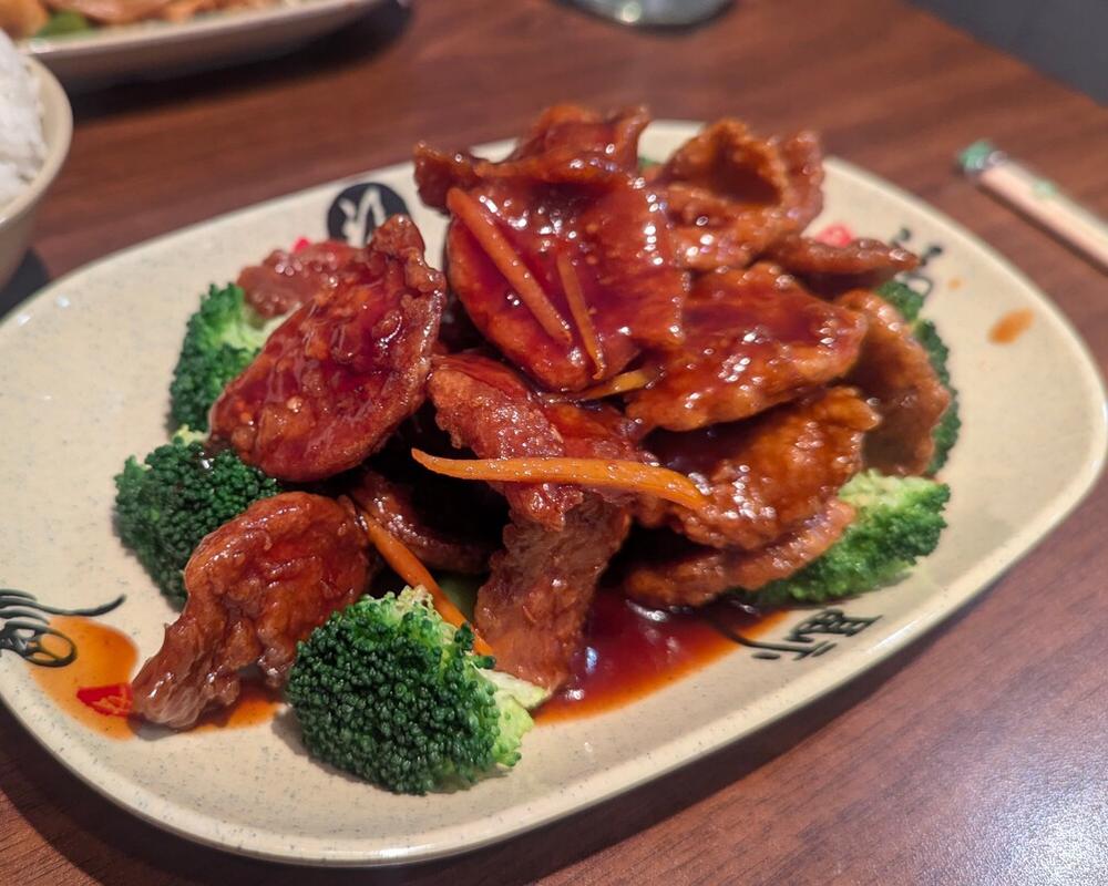 Thin slices of soy chicken, breaded and deep fried, and tossed with a sweet and savory orange sauce. Served with a side of rice.