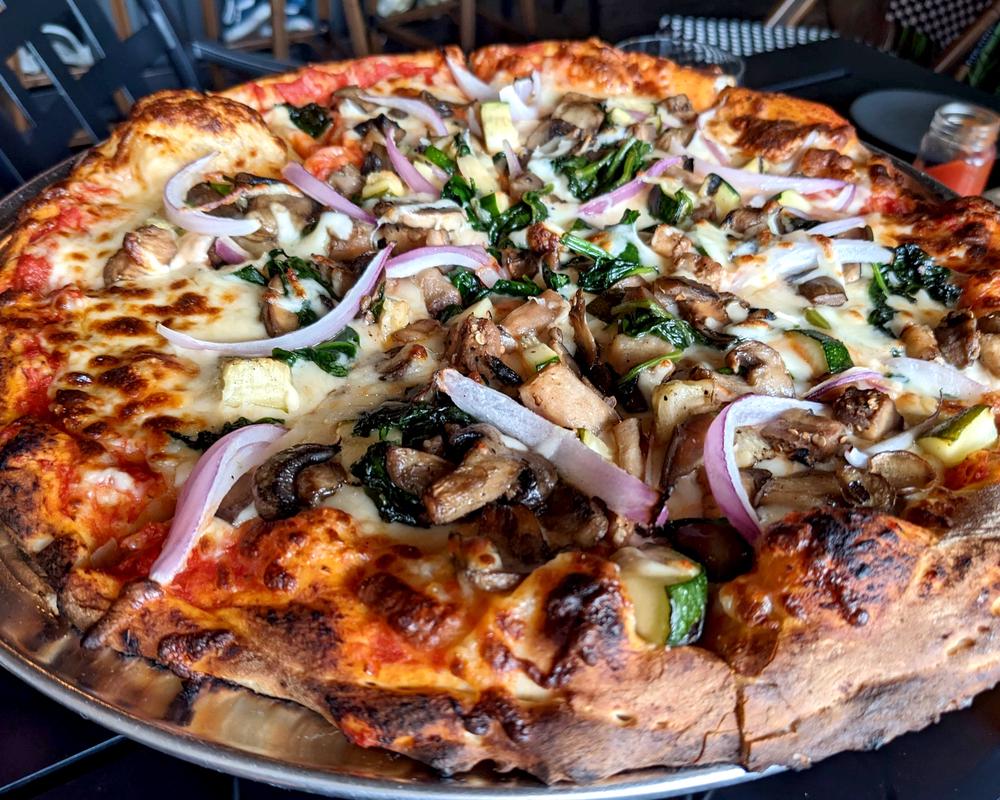 The pizzas are 14-inch diameter and loaded with toppings.